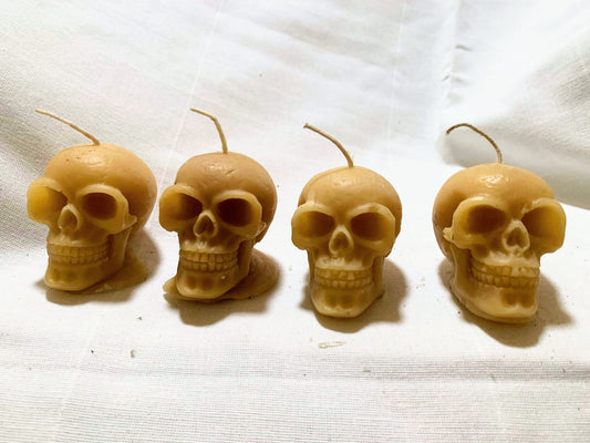 6 small skull candles made with bees wax